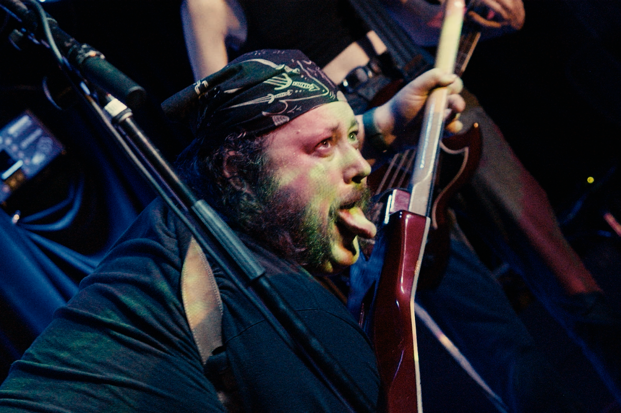 Man on stage sticking his tongue out