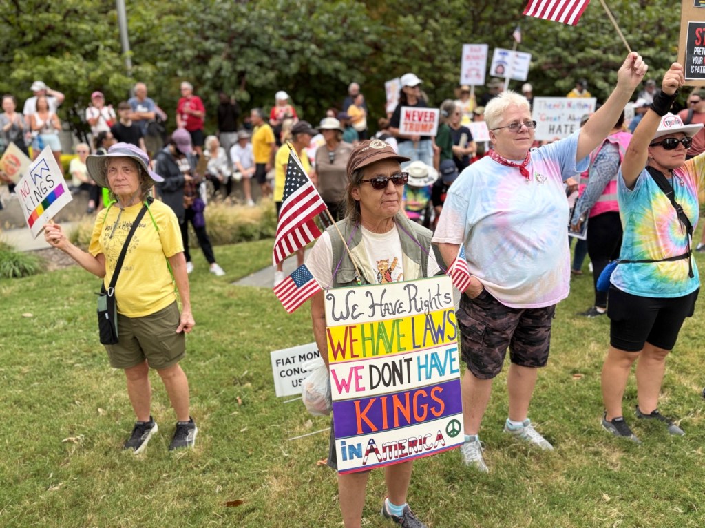 Woman with No Kings sign at Dallas protest