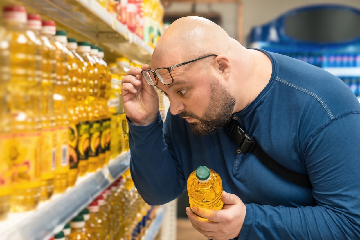 Man shocked by prices in grocery store.