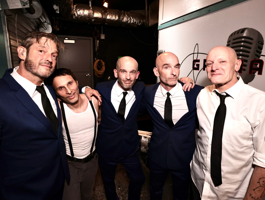 Men in suits posing for photos