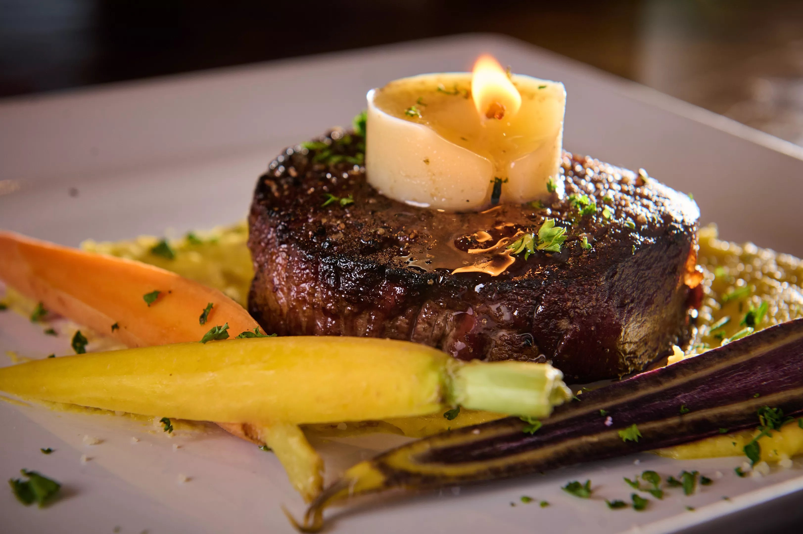 A tallow candle melts into a filet at Beckley 1115.