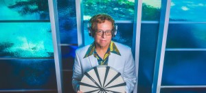 Dallas DJ Mark Ridlen holds a clock.