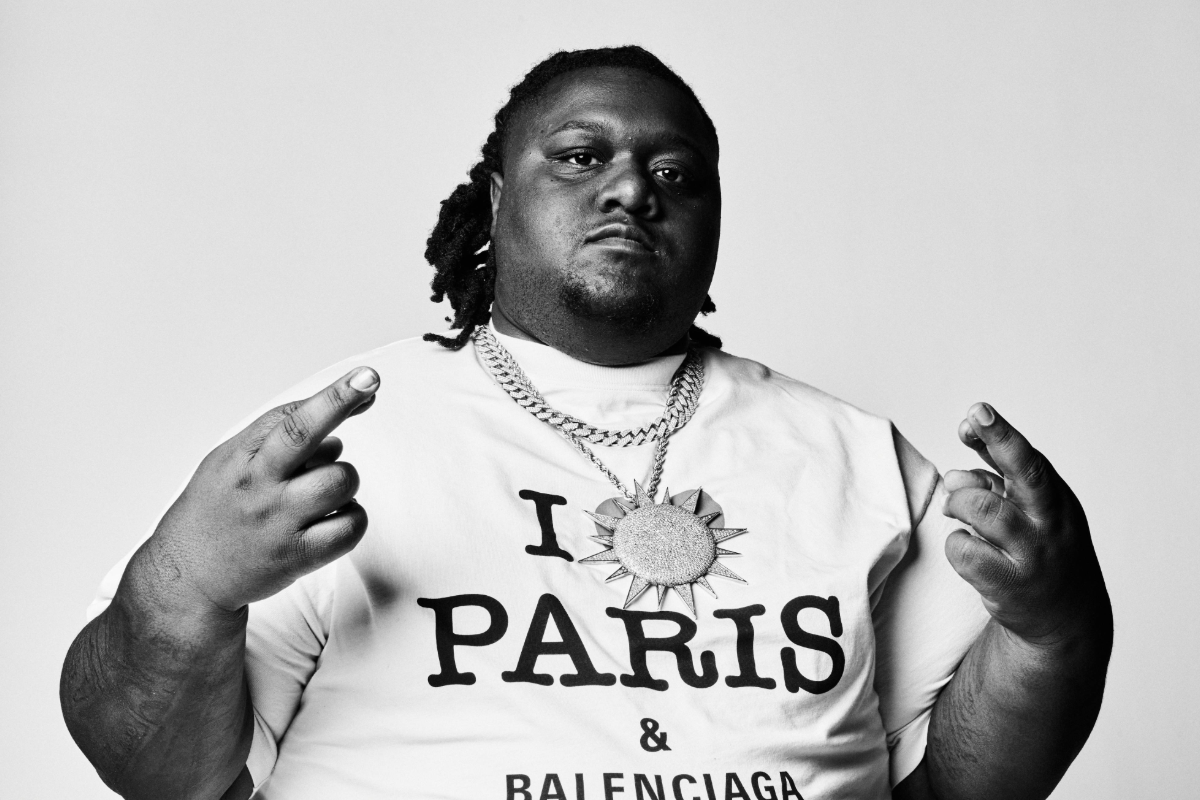 Man with the necklace on standing