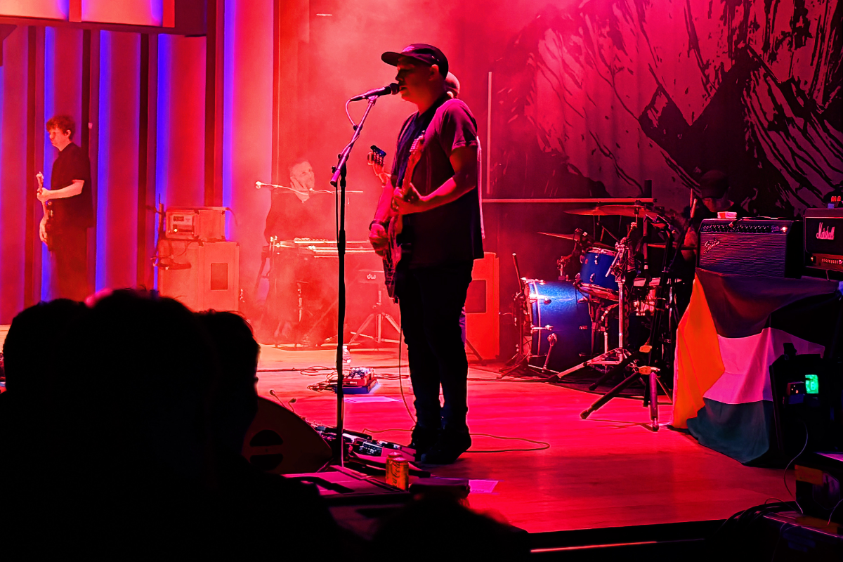 Man on stage performing in front of crowd