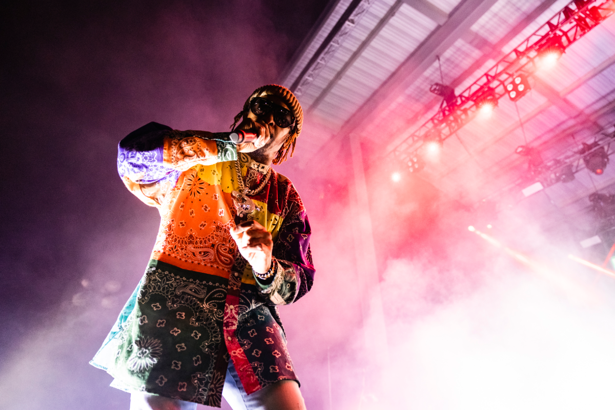 Man rapping on stage with a mic