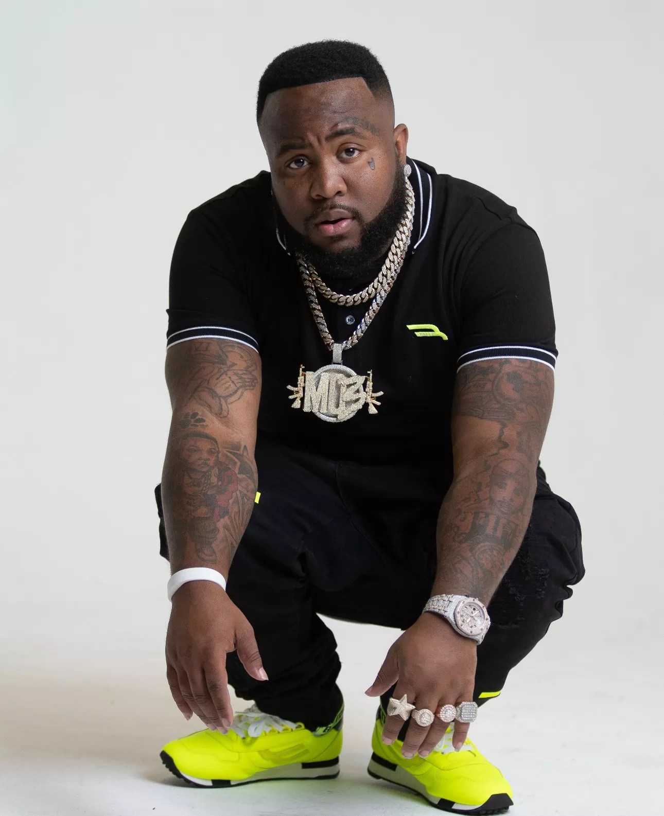 A man sitting down with chains