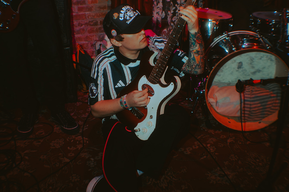 Man playing the guitar on the ground