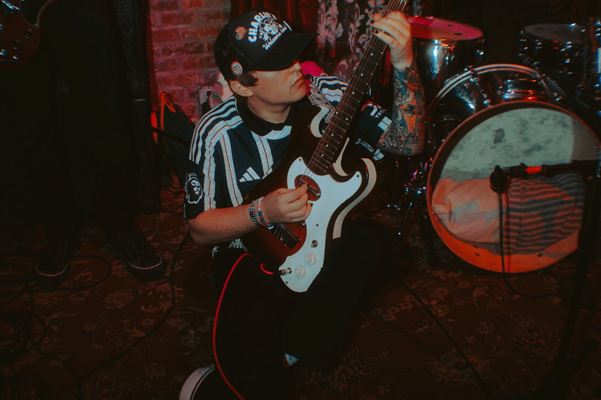Man playing the guitar on the ground