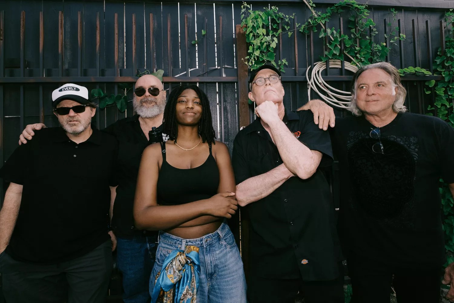 A band standing in front of a fence