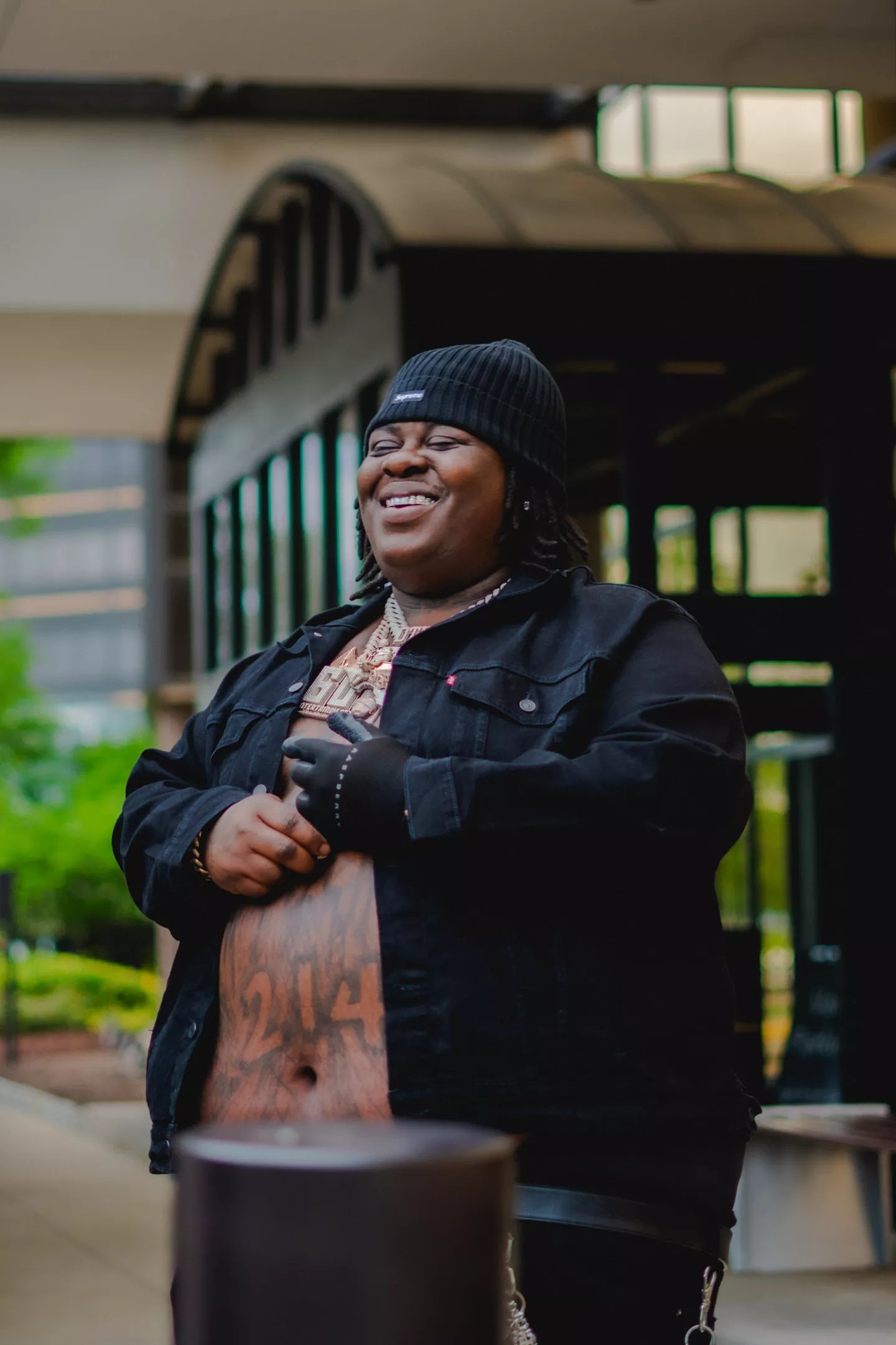Man smiling in front of building