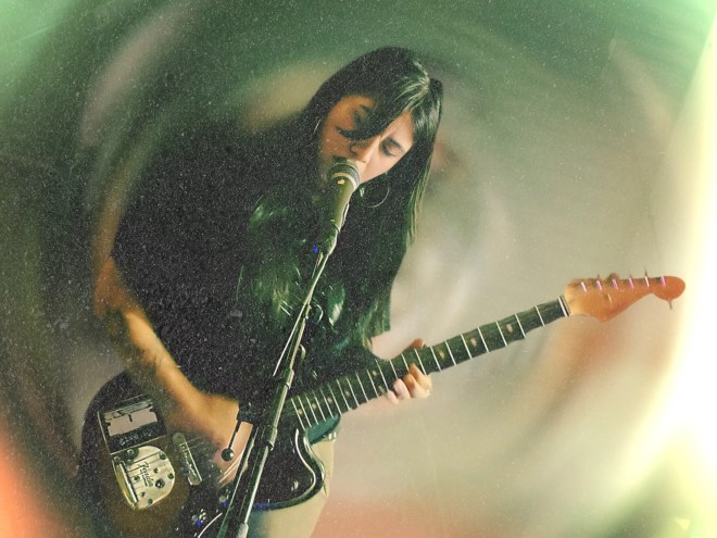 Woman performing with a guitar