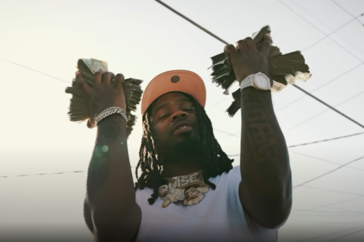 Man holding wads of cash